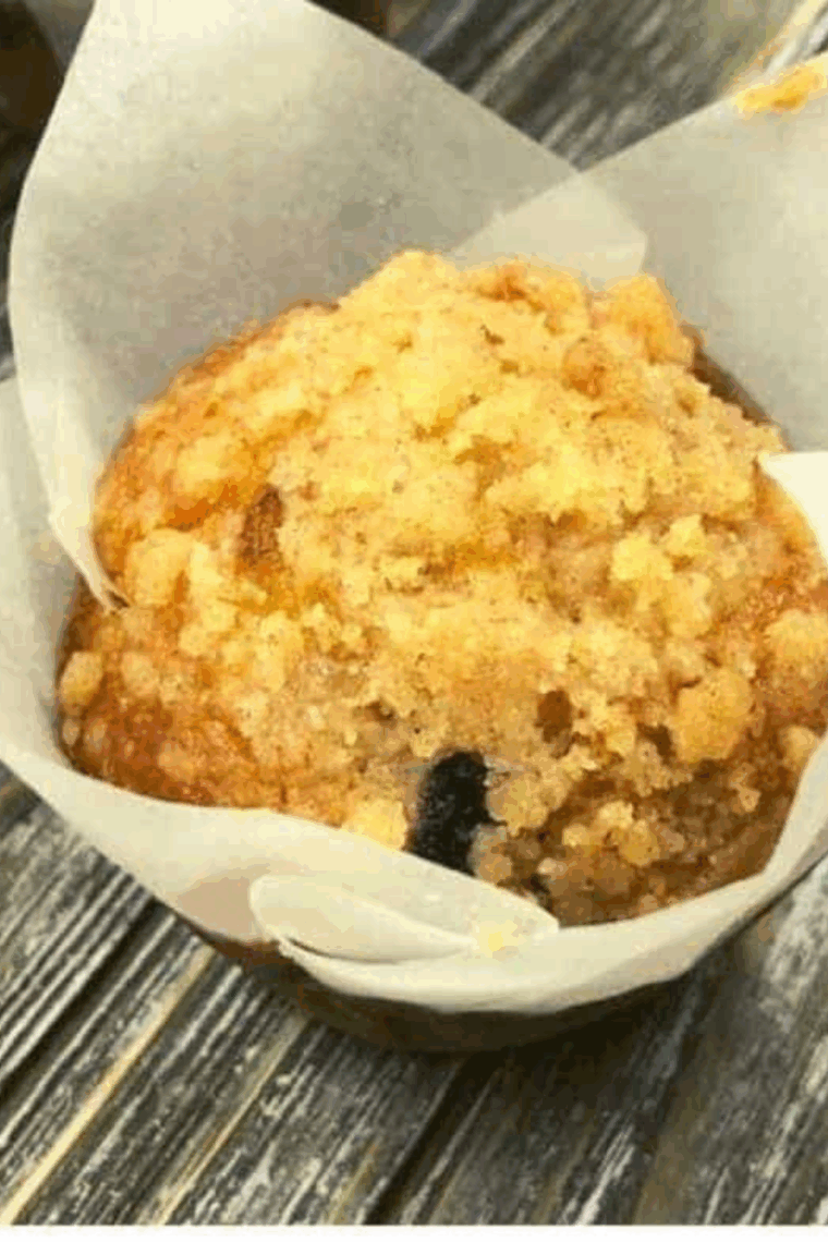 Golden air fryer muffins bursting with wild blueberries and a sweet crumb topping