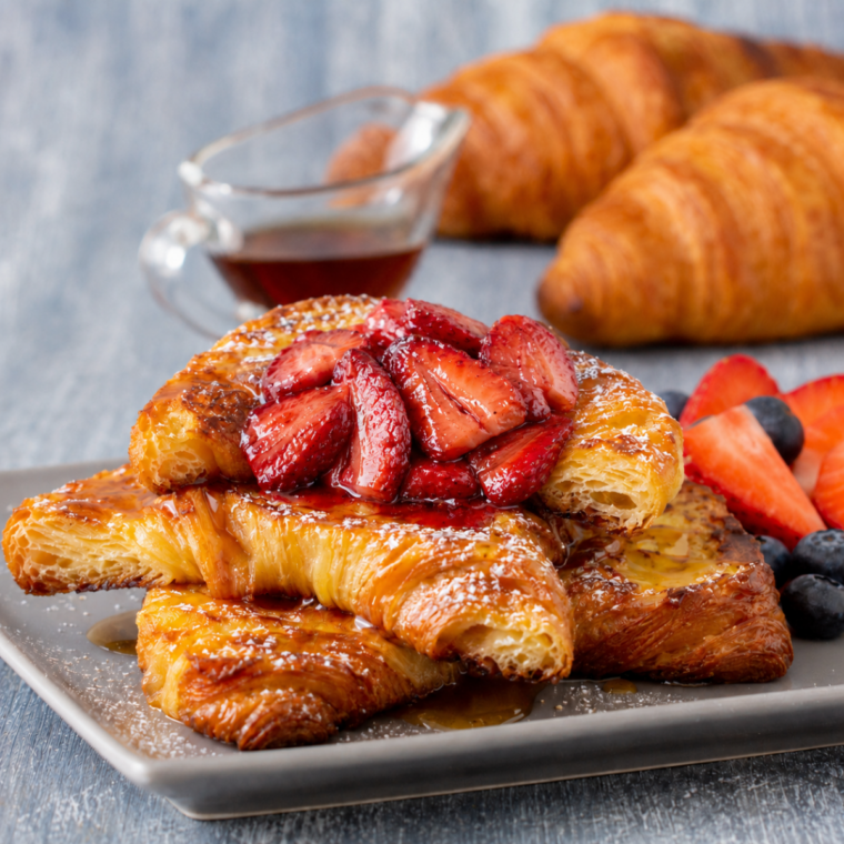 Air Fryer Croissant French Toast with Strawberries on a white plate