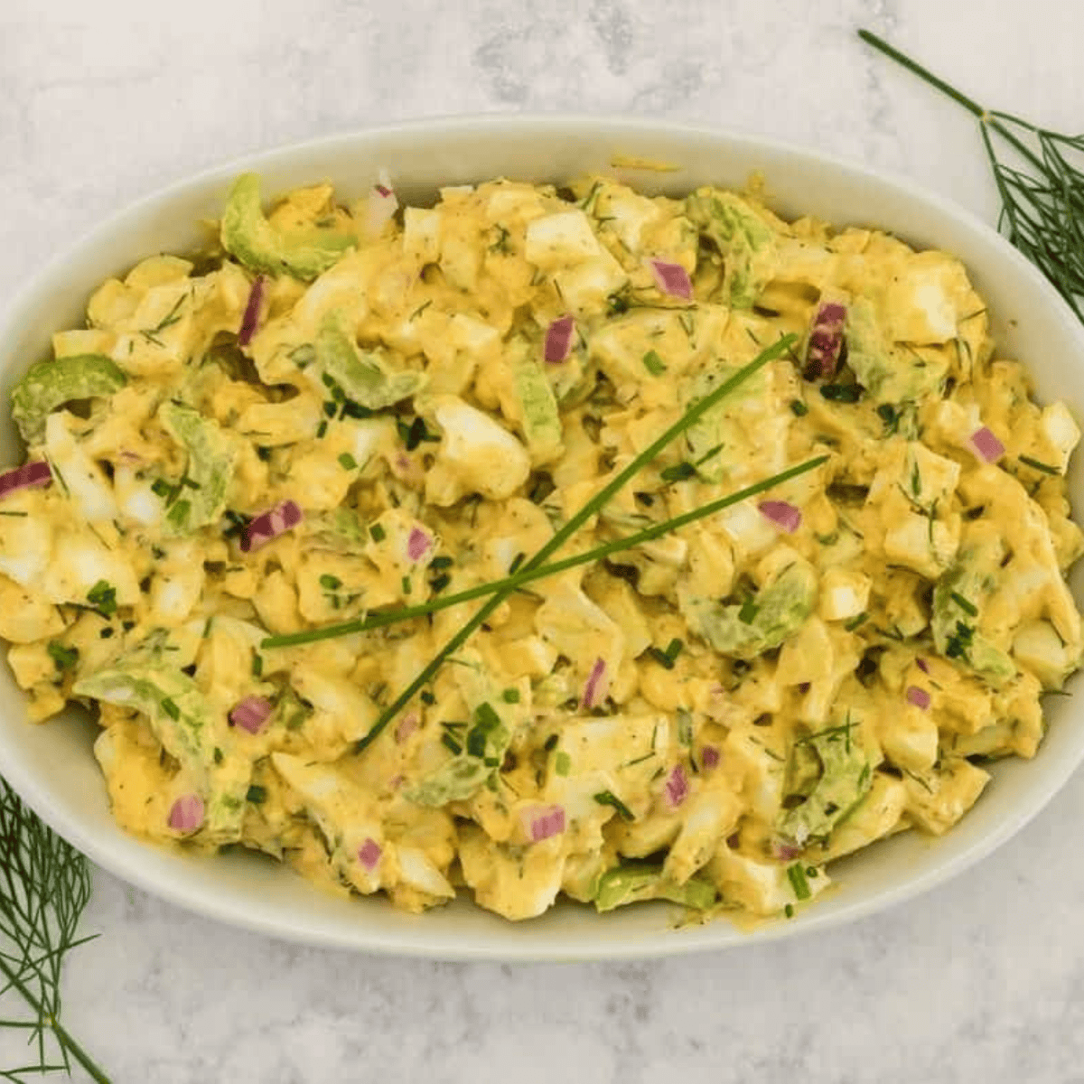 Creamy air fryer egg salad served on toasted bread with lettuce, ready to enjoy as a fresh, delicious sandwich.