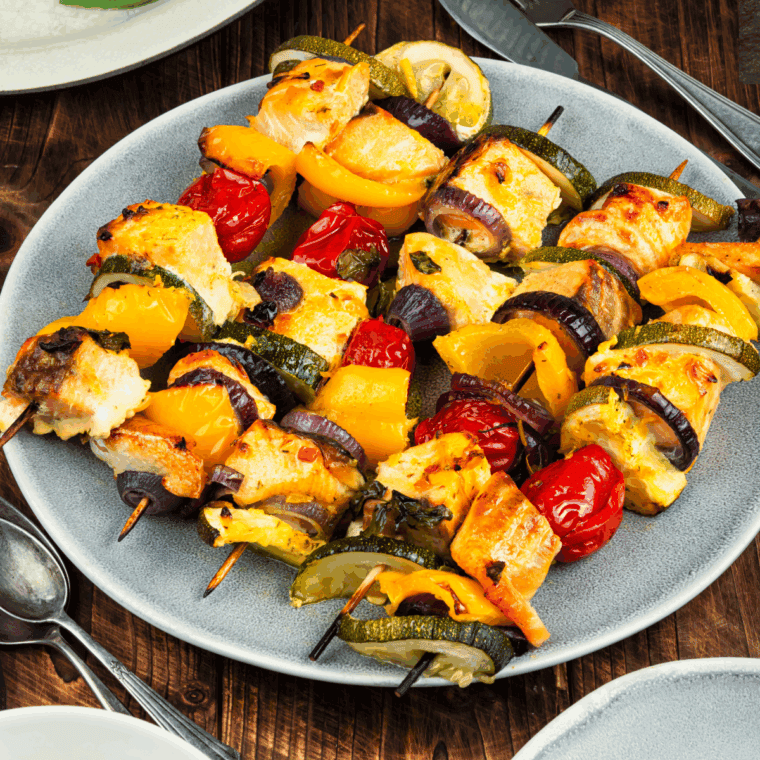 Plate of Air Fryer Salmon Kebabs on wooden table.