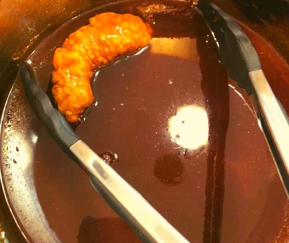 Dipping Chicken Tenders into Sauce