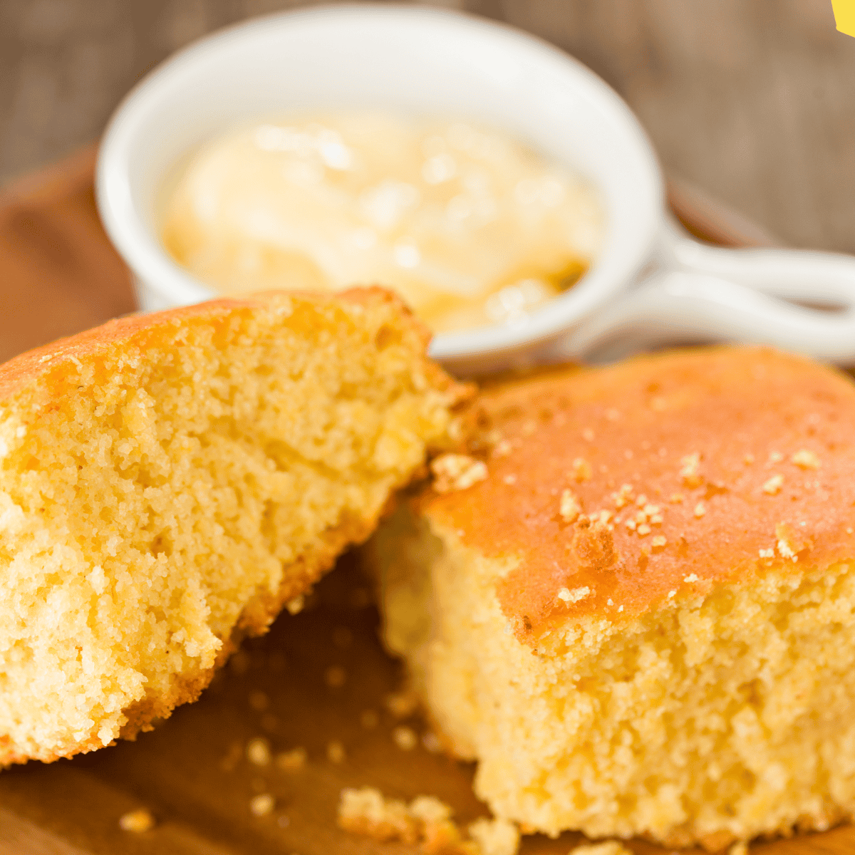 Golden, fluffy Boston Market-style cornbread squares on a white plate, ready to serve.