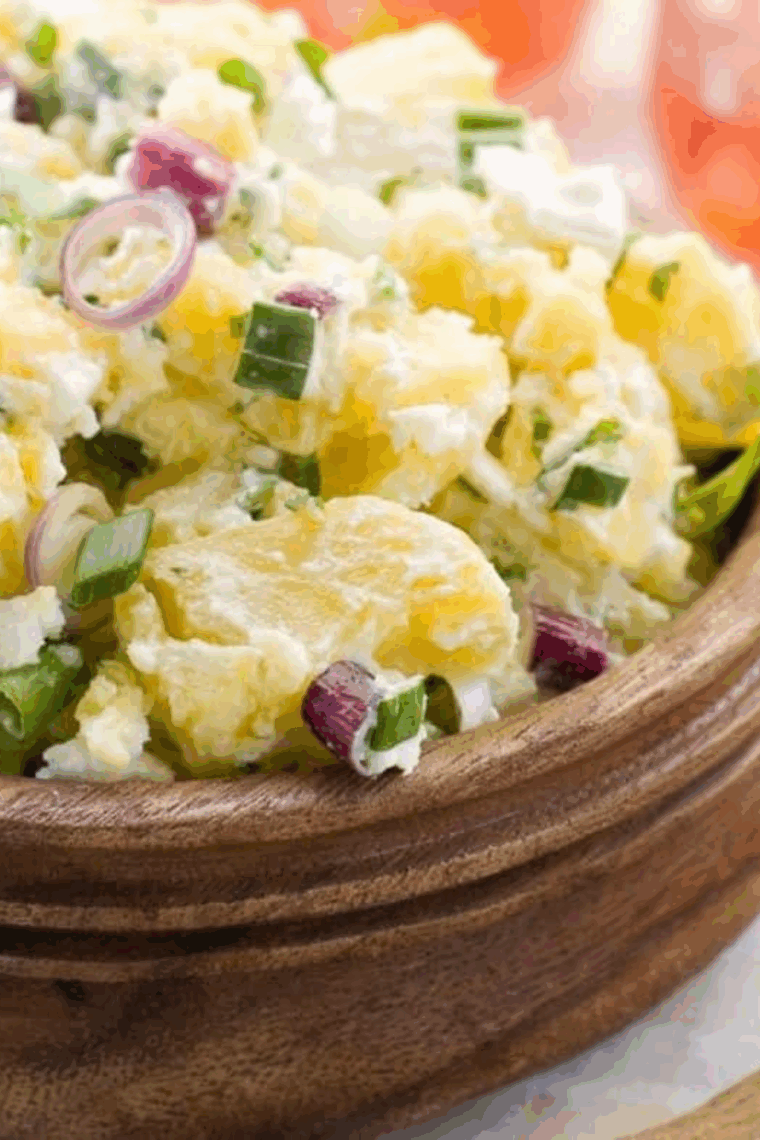 Bowl of creamy Hellmann’s Original Potato Salad with chopped potatoes, eggs, onions, and classic seasonings.