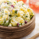 Bowl of creamy Hellmann’s Original Potato Salad with tender potato chunks and classic seasonings.