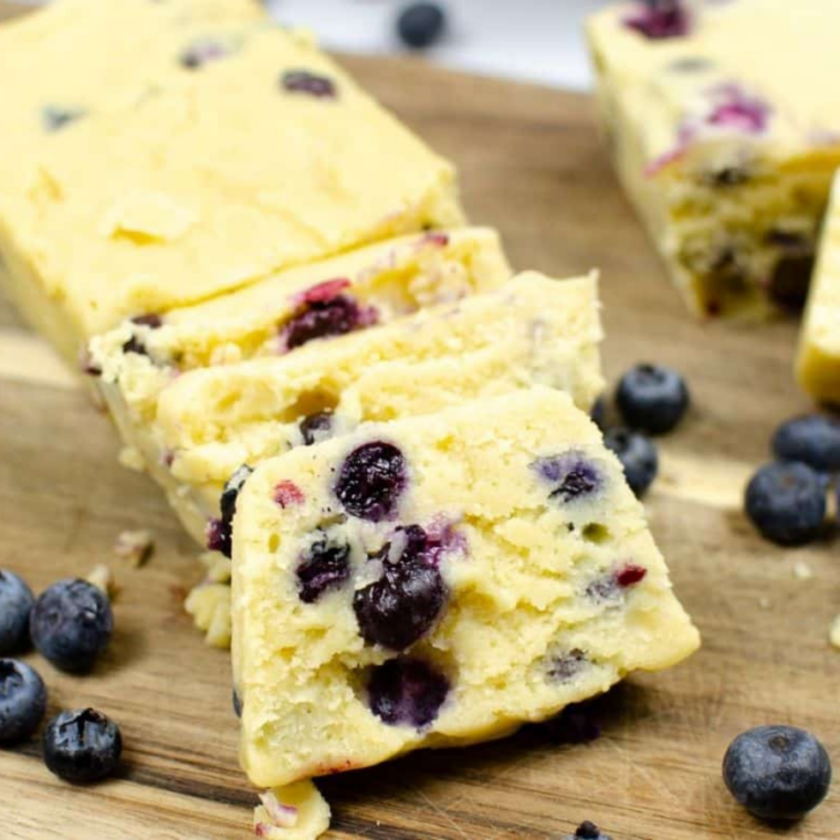 Pouring blueberry loaf batter into prepared pan before placing it in Instant Pot to cook