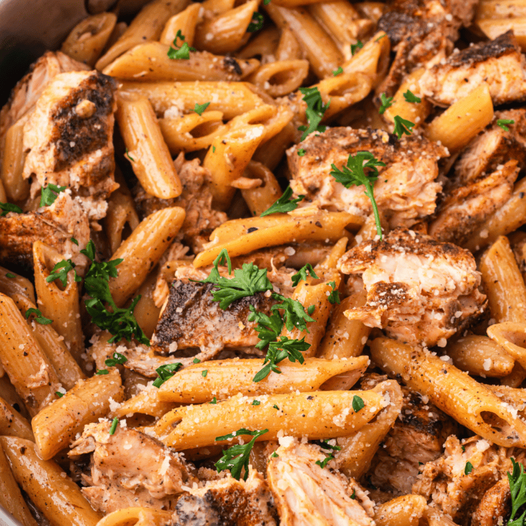 One-pot Cajun Chicken Alfredo in the Instant Pot with creamy pasta and blackened chicken pieces.