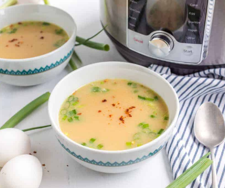 "Garnishing Chinese Imperial Palace Egg Drop Soup with green onions and a dash of white pepper."