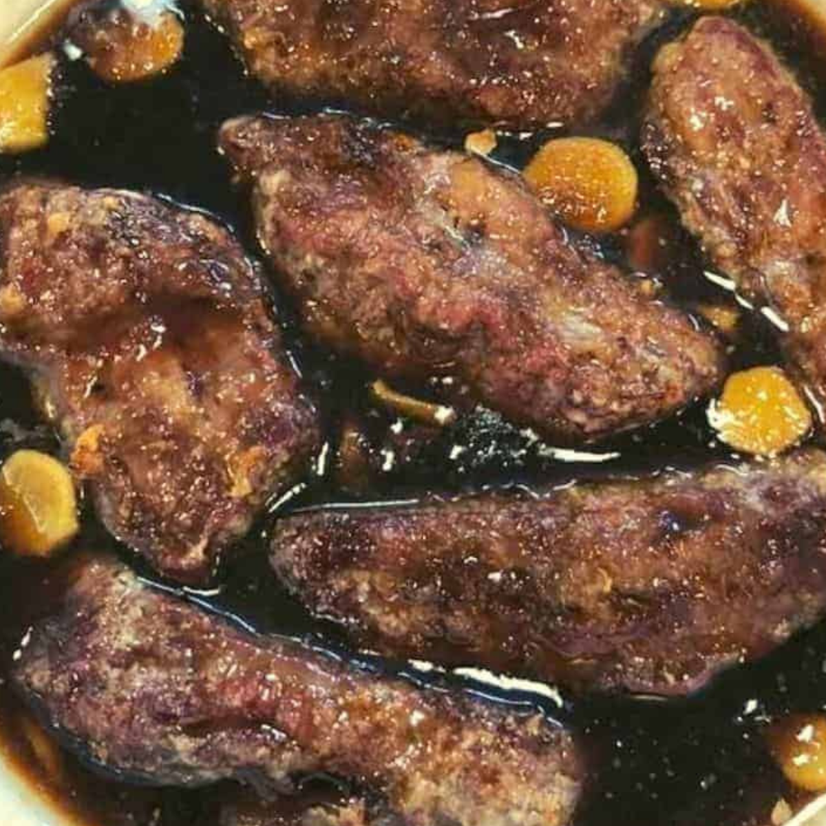 Toss the cooked flank steak in a marinade.