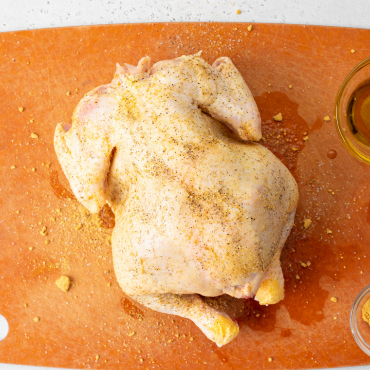 Raw Cornish hens patted dry and seasoned with salt, pepper, and herbs