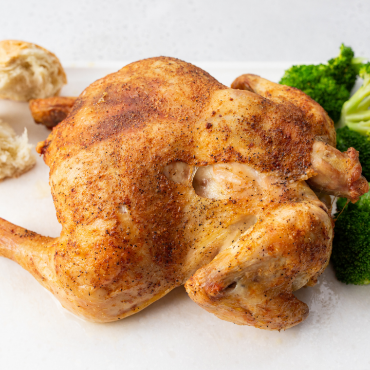 Cooked Cornish hen kept warm under foil while the next one air fries