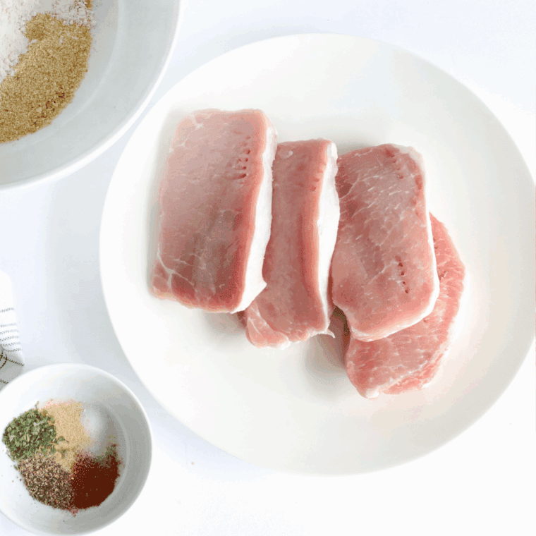 Patting pork chops dry with a paper towel so the seasoning adheres.