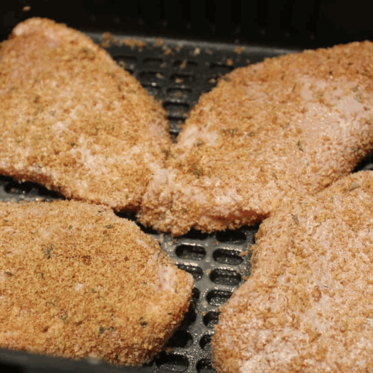 Air Fryer Mexican Pork Chops resting on a plate with a crispy breadcrumb crust.