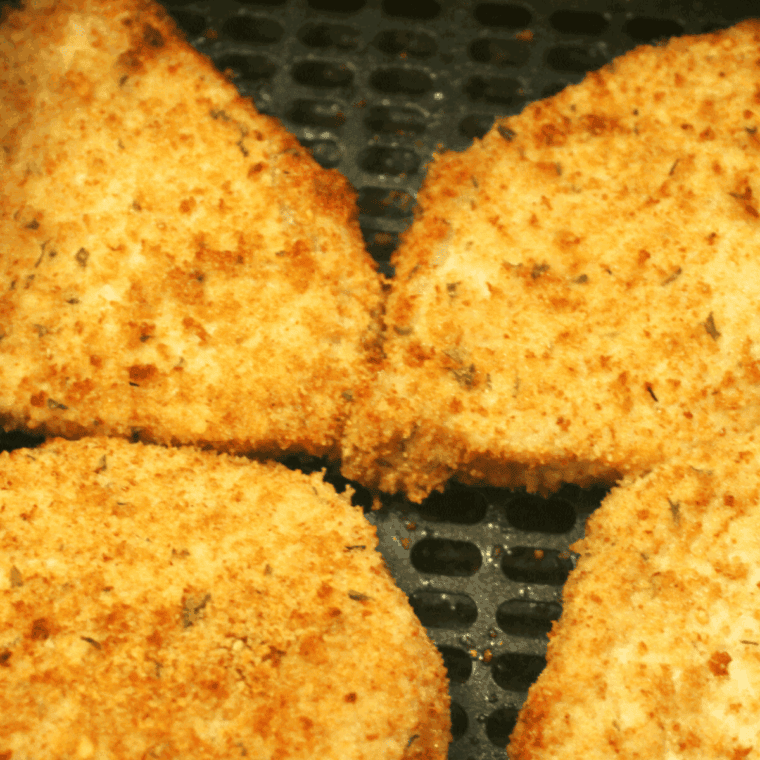 Sliced Air Fryer Mexican Pork Chop showing a juicy interior and golden coating.