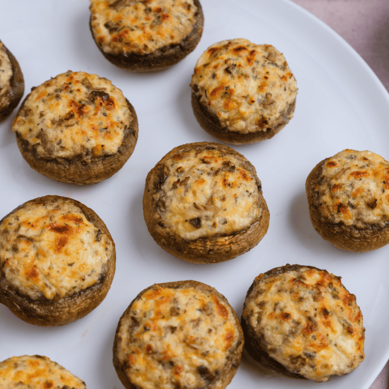 Carrabba’s Italian Grill Stuffed Mushrooms Parmigiana filled with pepperoni, vegetables, and topped with Parmesan cheese, served with creamy tomato sauce.