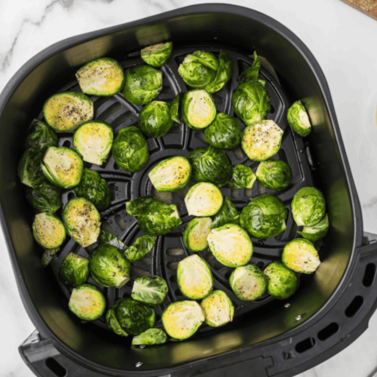  Arrange seasoned Brussels sprouts in the air fryer basket in a single layer, ensuring they are not overcrowded for even cooking.