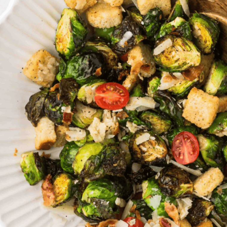 Golden brown and crispy Copycat Ruth Chris Brussels Sprouts made in the air fryer, served on a plate with a rich, caramelized flavor.