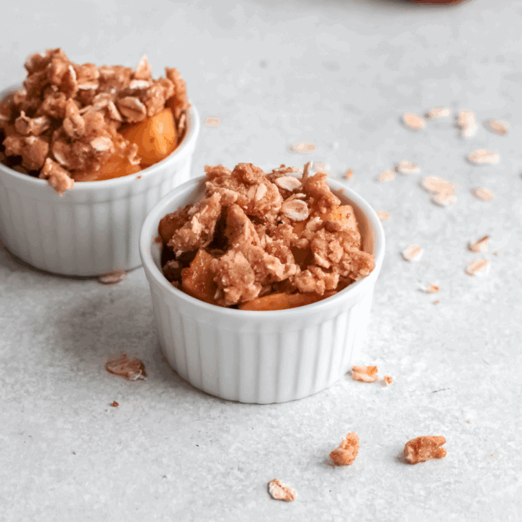 Warm Cracker Barrel Apple Crisp copycat recipe topped with a scoop of melting vanilla ice cream.