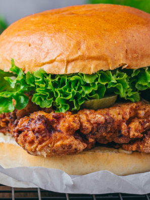 Ina Garten fried chicken sandwich with buttermilk herb mayo, lettuce, and pickles on a toasted potato bun