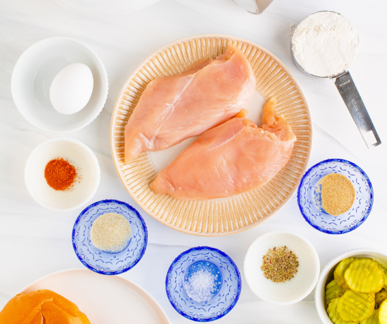 Ingredients for copycat Ina Garten fried chicken sandwiches arranged on a marble counter