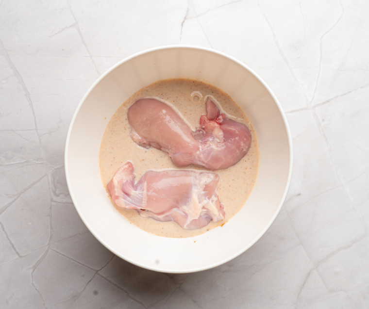 Chicken breast pounded to an even half-inch thickness between parchment sheets