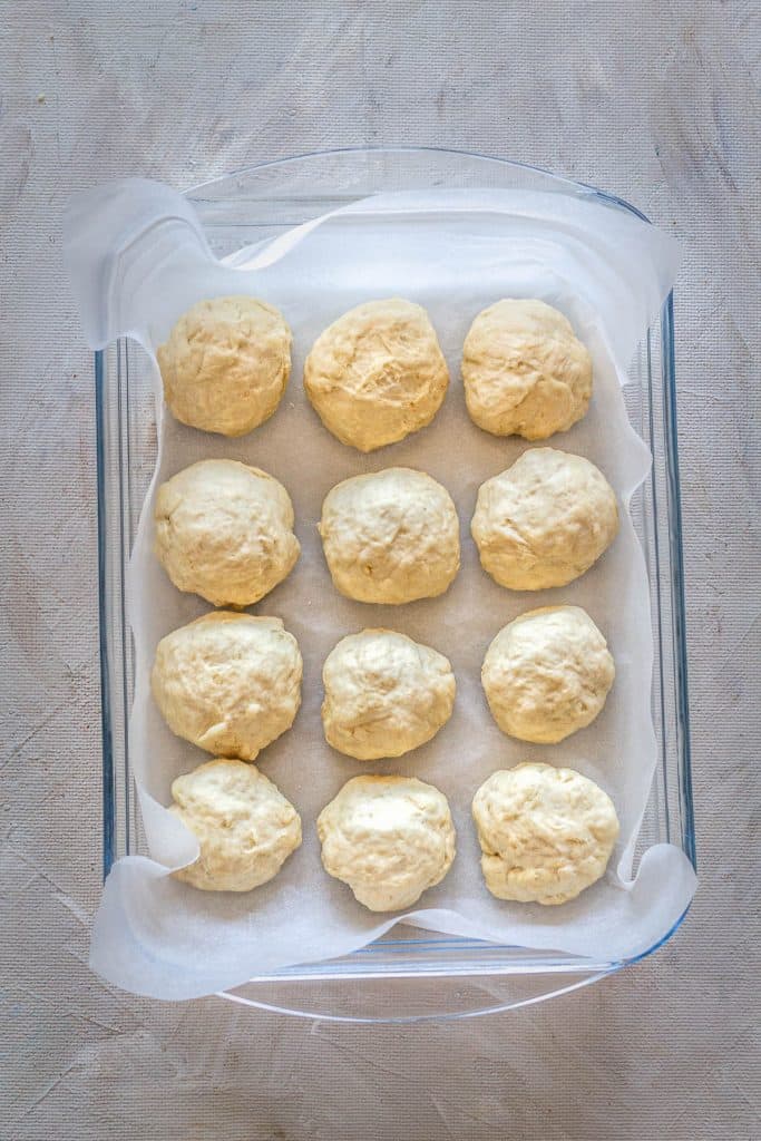 Place dinner rolls into a baking pan.