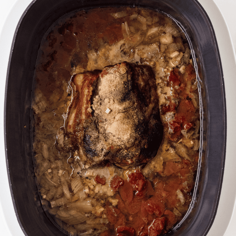 Seasoned pork shoulder browning in oil using the Instant Pot Sauté function.