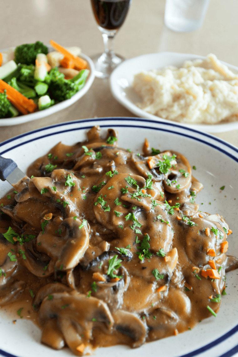 Restaurant-style Chicken Marsala with golden chicken, mushrooms, and rich Marsala wine sauce served on a plate.