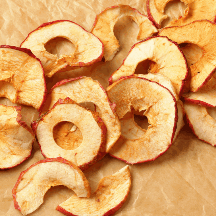 Crispy air fryer apple chips in a bowl, golden brown and ready to eat.