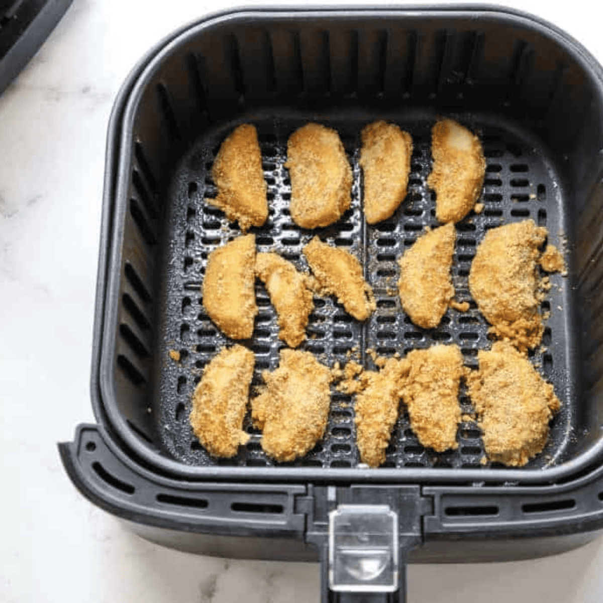 Apple wedges being dredged in egg and cinnamon-sugar crumbs