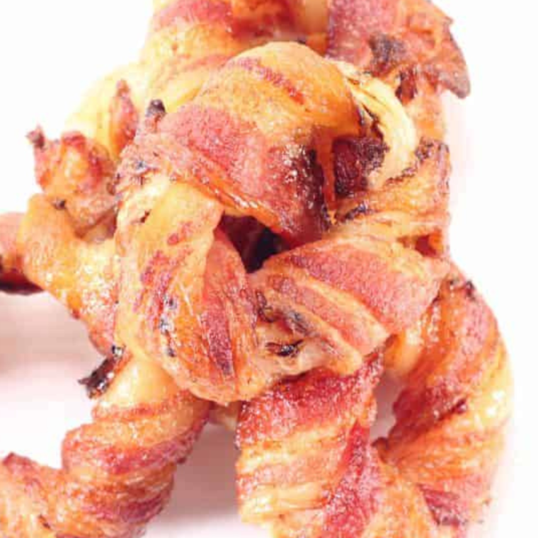 Crispy Air Fryer Bacon Wrapped Onion Rings served as a delicious appetizer or snack.