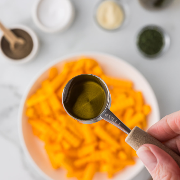 Peeled and sliced butternut squash fries ready for seasoning