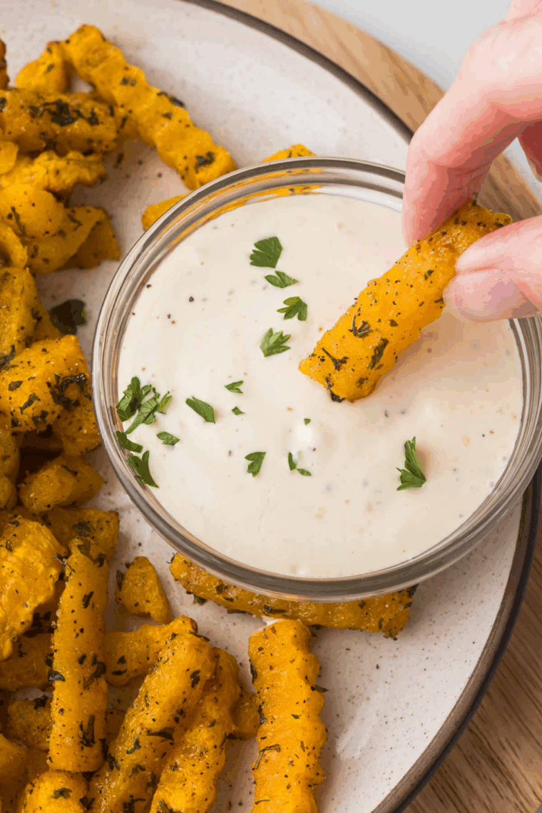Air fryer butternut squash fries cooked until golden and crispy on a plate