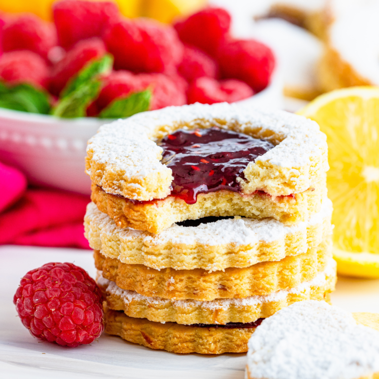Air Fryer Linzer cookies with raspberry preserves, topped with powdered sugar, and served as a delicious homemade treat.