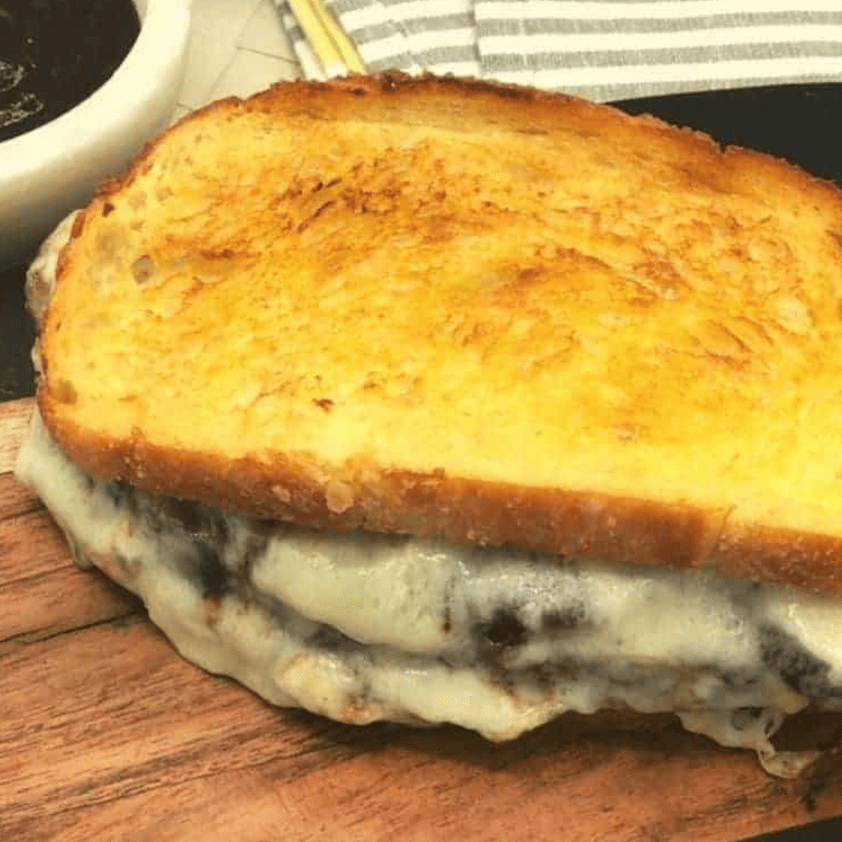 "Golden brown Air Fryer Meatloaf Sandwich with melted cheese oozing out."