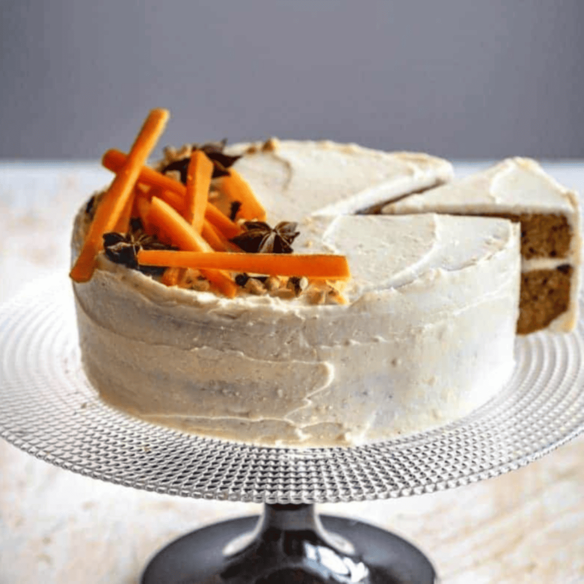 Slice of Cheesecake Factory-style carrot cake cheesecake with cream cheese frosting