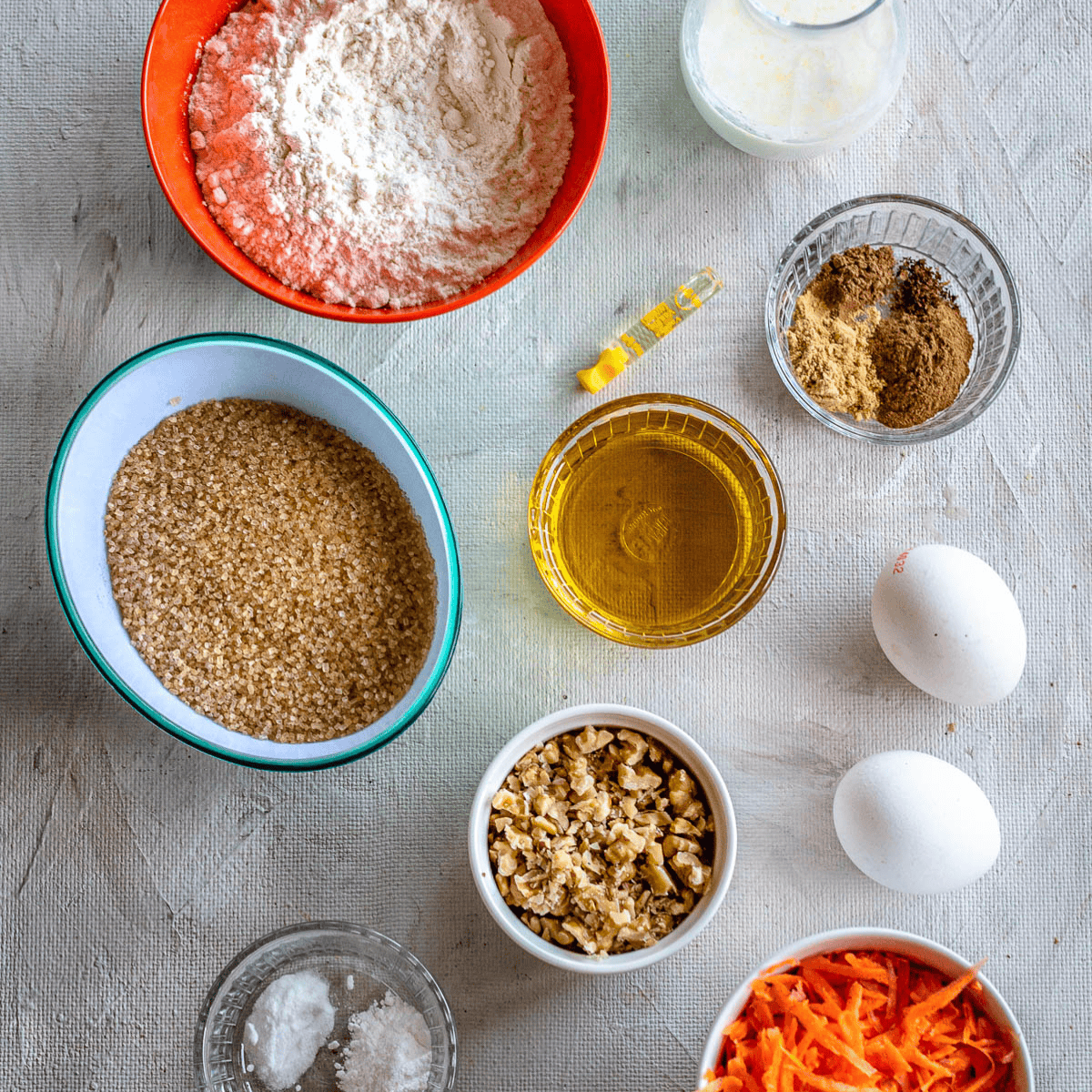 Ingredients needed for Carrot Cake Cheesecake Factory Recipe on kitchen table.