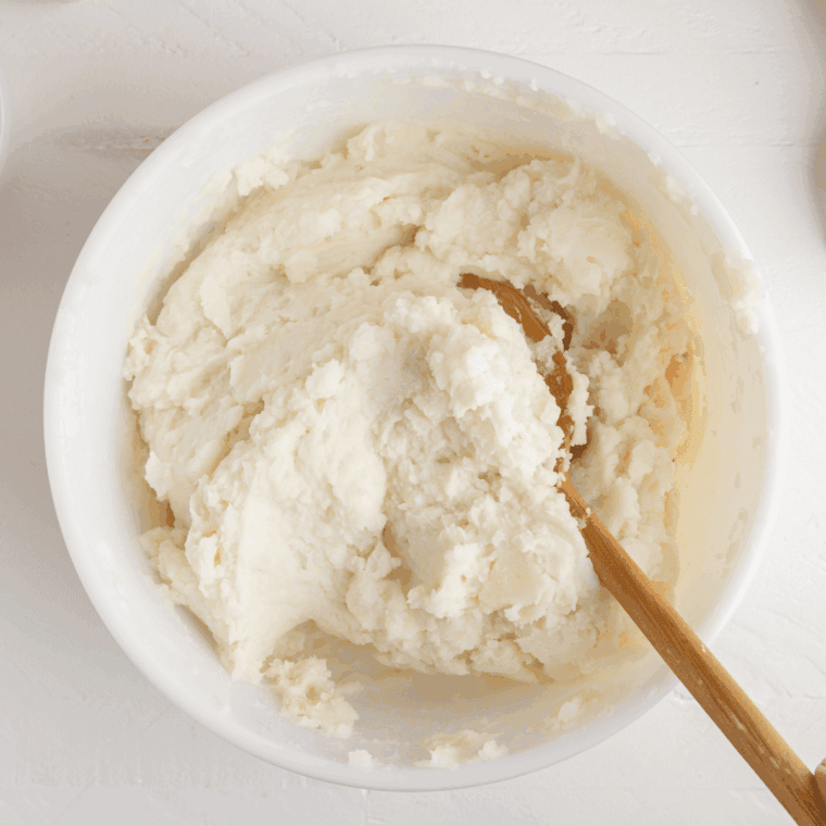 Smooth mashed potatoes in mixing bowl.