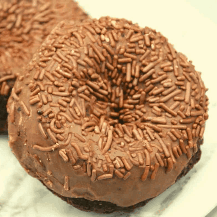 Chocolate glazed donut Tim Hortons copycat on a cooling rack with rich glaze topping.