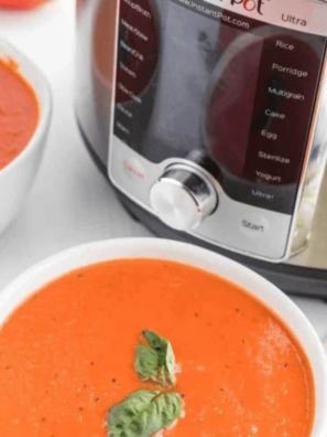 Bowl of creamy copycat Nordstrom tomato basil soup garnished with fresh basil leaves