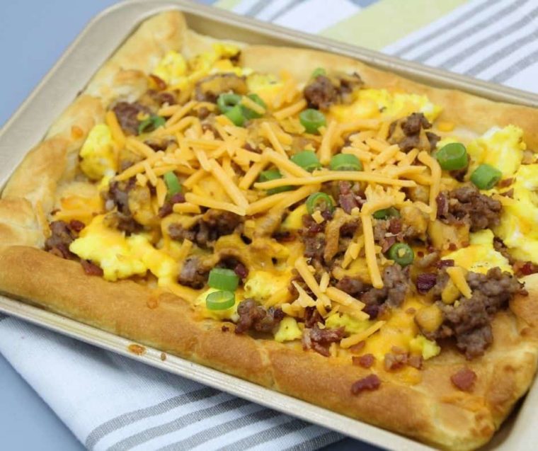 cooked crescent roll breakfast pizza on an air fryer rack