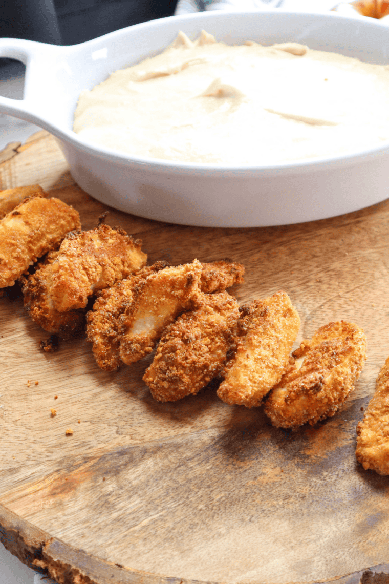 Bowl of smooth and creamy Auntie Anne’s sweet caramel dip ready for dipping pretzels