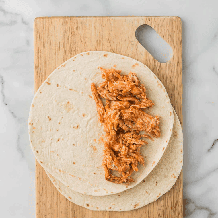 Sauté shredded chicken in the Instant Pot for 3 minutes, stirring frequently to thicken sauce.