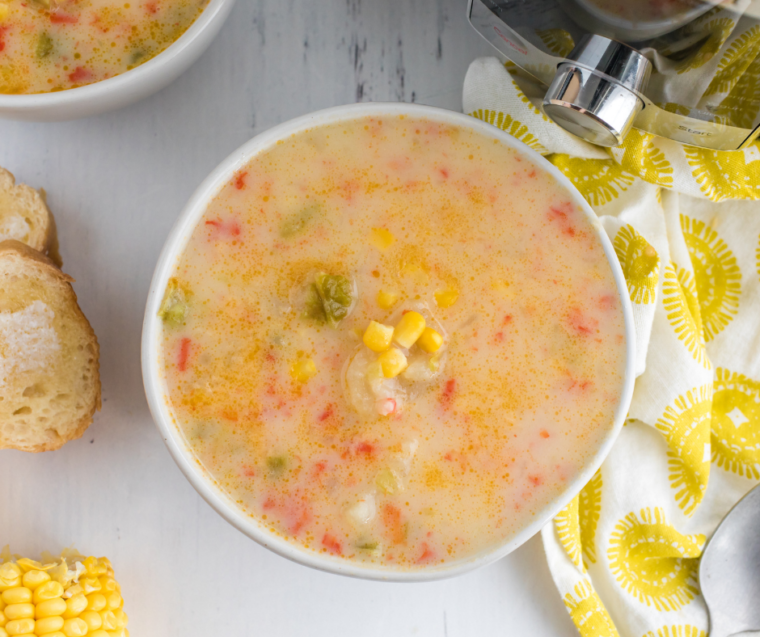 "Close-up of creamy Instant Pot Copycat Panera Corn Chowder with chunks of corn and potatoes visible."