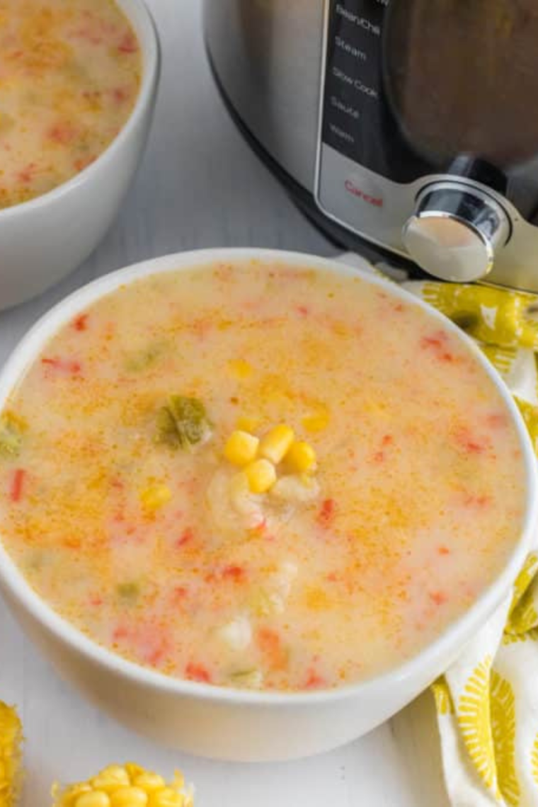 "Instant Pot Copycat Panera Corn Chowder served with a side of crusty bread and a dollop of sour cream."