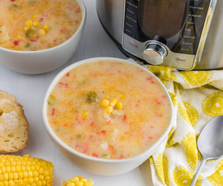 "Close-up of creamy Instant Pot Copycat Panera Corn Chowder with chunks of corn and potatoes visible."