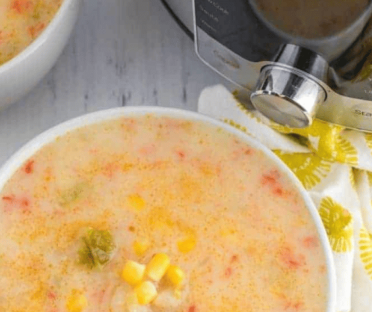 "A bowl of Instant Pot Copycat Panera Corn Chowder garnished with fresh chives and a sprinkle of paprika."