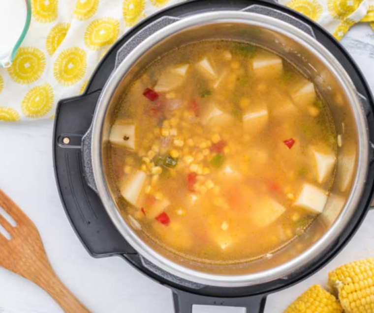 "Instant Pot displaying the cooked Panera Summer Corn Soup, ready to be stirred and served."