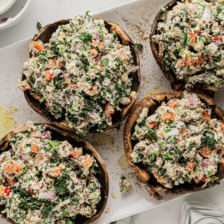 Spoon spinach mixture into mushroom caps, press gently, and brush tops with melted butter.
