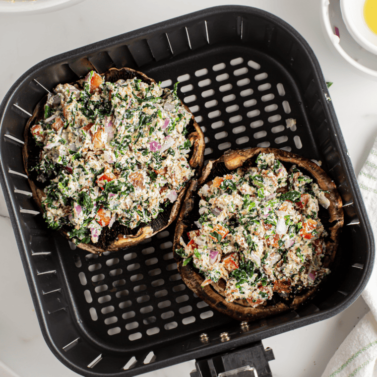 Preheat air fryer to 375°F, arrange stuffed mushrooms, and cook for 8-10 minutes.