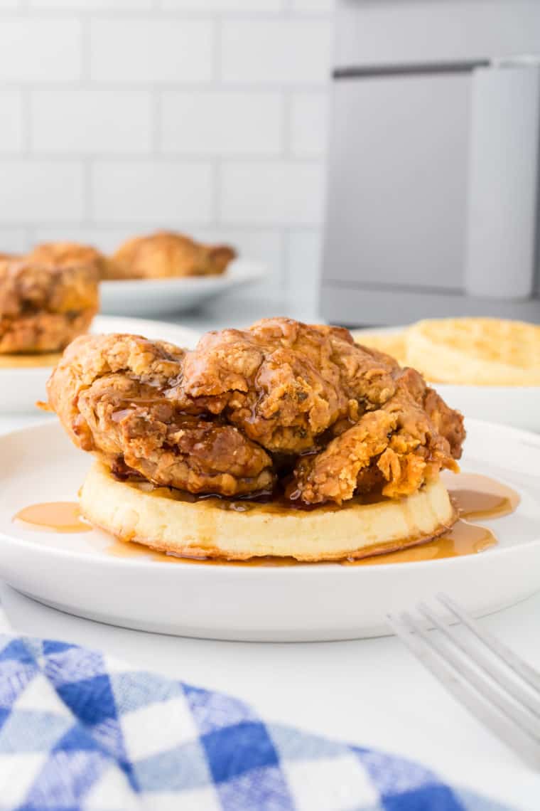 Air Fryer Chicken and Waffles with Maple Syrup - A serving of air fryer chicken and waffles topped with maple syrup and a dusting of powdered sugar.


 
